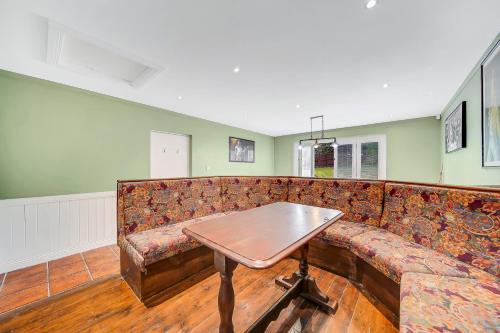 a couch with a wooden table in a room at Spacious Coastal Accommodation with Games Room - Sleeps 10 in Rathmullan