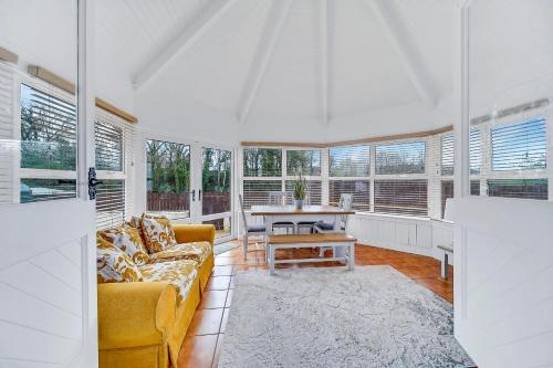 a living room with a couch and a table at Spacious Coastal Accommodation with Games Room - Sleeps 10 in Rathmullan
