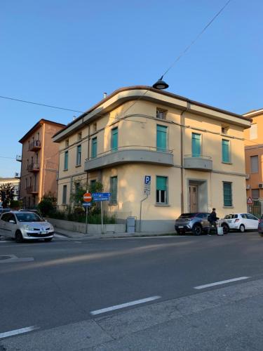 a building on the side of a street with parked cars at Pisa City Home in Pisa