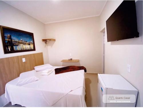 a hospital room with two beds and a flat screen tv at HOTEL MANTORAMOS in Bilac