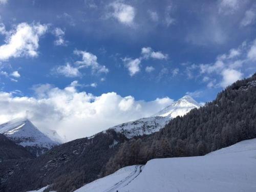 a view of a snowy mountain range with snow covered mountains at Almhuette-Gipper in Heiligenblut