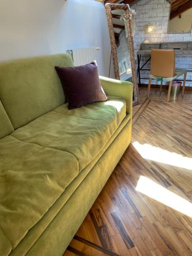 a green couch sitting in a living room at Boutique Villa Etna d'A'mare in Trecastagni