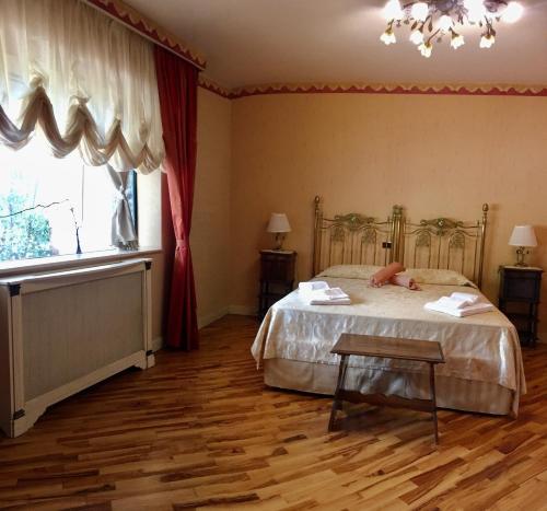 a bedroom with a bed and a window at Boutique Villa Etna d'A'mare in Trecastagni