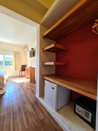 a living room with wooden shelves on the wall at Nova Posada in Colonia del Sacramento