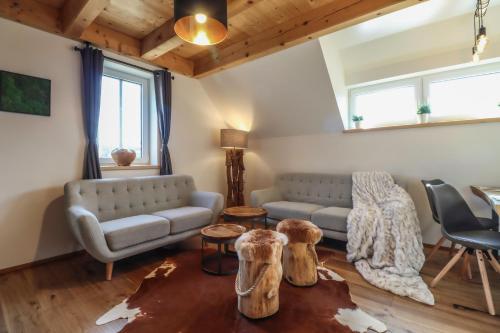a living room with a couch and a table at WOODHOME - Luxury Mountain Apartment Horní Malá Úpa in Horní Malá Úpa