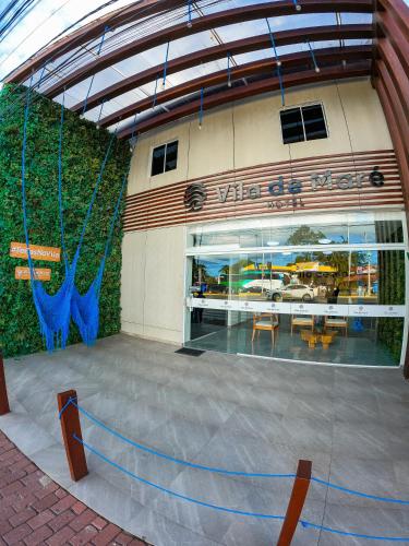 a view of a building with a table and chairs at Vila de Maré Hotel in Porto De Galinhas
