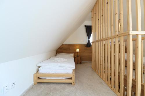 a small room with a bed and a staircase at WOODHOME - Luxury Mountain Apartment Horní Malá Úpa in Horní Malá Úpa