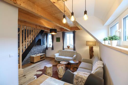 a living room with a couch and a table at WOODHOME - Luxury Mountain Apartment Horní Malá Úpa in Horní Malá Úpa