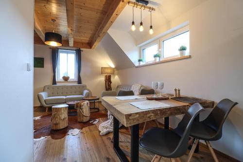 a living room with a table and chairs at WOODHOME - Luxury Mountain Apartment Horní Malá Úpa in Horní Malá Úpa
