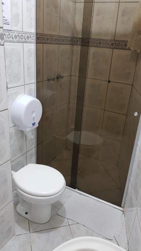 a bathroom with a toilet and a shower at Pousada Pedra das Tartarugas in São Francisco do Sul