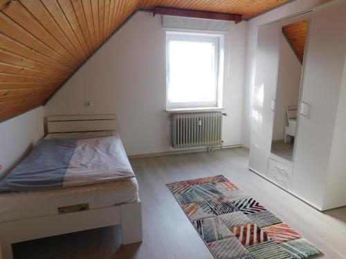 a bedroom with a bed and a window and a rug at Lichtblick in Wangerland
