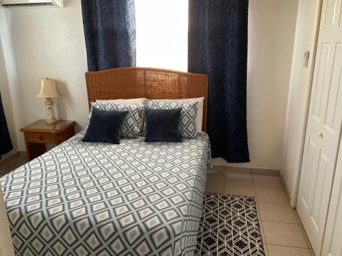 a bedroom with a bed with two pillows and a window at Tropical View Villas in Hartswell