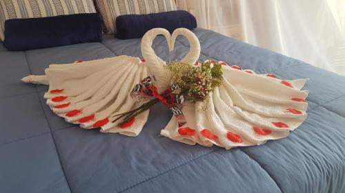 two swansuitsrendered to look like they are on a bed at Pousada Pedra das Tartarugas in São Francisco do Sul