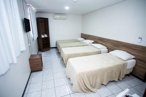 Ένα ή περισσότερα κρεβάτια σε δωμάτιο στο Hotel Campina Executivo
