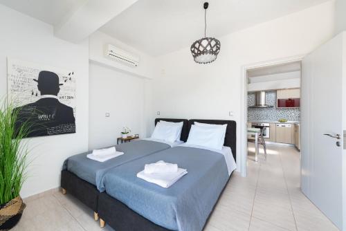 a bedroom with a large bed and a kitchen at Alina in Ialysos