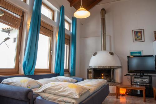 a living room with a couch and a fireplace at Sunray Luxury Apartment Zagora with piano in Zagora