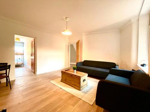 a living room with a couch and a coffee table at Huge serviced Apartment with FREE PARKING in Jesmond