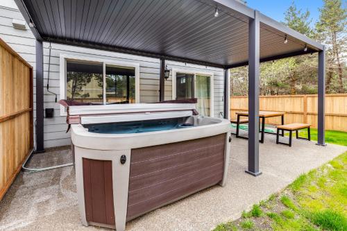 a hot tub on a patio with a black cover at SurfSide in Westport