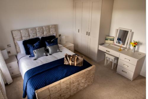 1 dormitorio con 1 cama grande y escritorio en Ashwoods House en Enniskillen