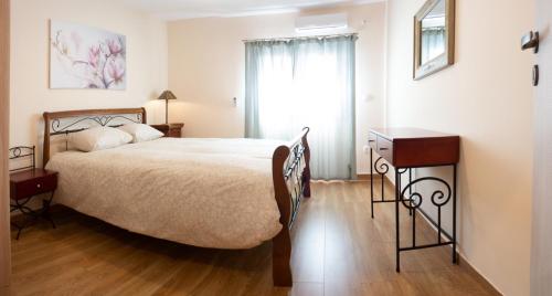 a bedroom with a large bed and a window at Αcacia House - Fully Equipped Apartment in Glyfada in Athens