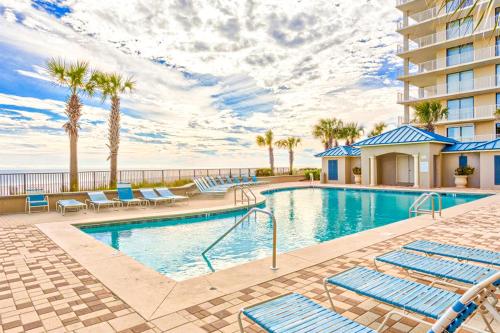 a swimming pool with lounge chairs and a resort at Bluewater in Orange Beach