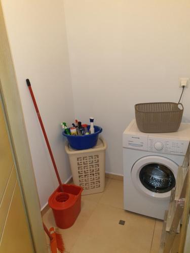 a laundry room with a washing machine and a mop at Δροσιά in Nafplio