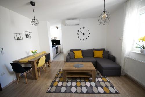 a living room with a couch and a table at Apartmani JURIĆ in Međugorje