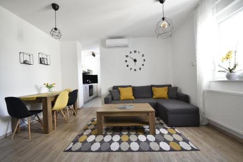 a living room with a couch and a table at Apartmani JURIĆ in Međugorje