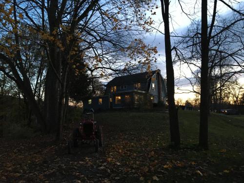 a house in the middle of a yard with trees at The Grayhaven Motel in Ithaca
