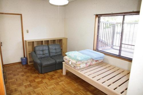 a living room with a couch and a chair at Minpaku Taki - Vacation STAY 12842 in Gero