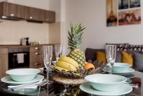 a table with a bowl of fruit on top of it at Grand Budapest Penthouse in Budapest