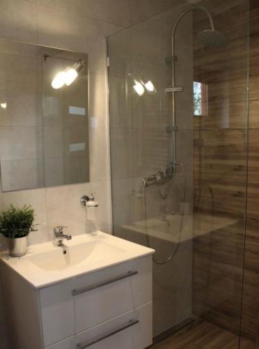 a bathroom with a sink and a shower at Morza szum in Karwia