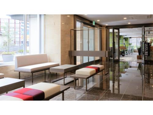 a lobby with benches and tables in a building at Center Hotel Narita 2 R51 - Vacation STAY 43391v in Narita