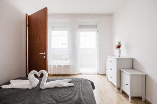 a bedroom with a bed with a swan decoration on it at Grand Budapest Penthouse in Budapest