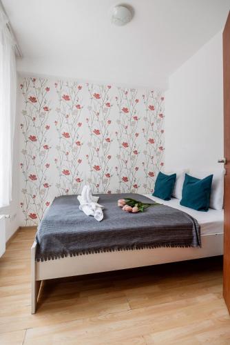 a bedroom with a bed with a floral wallpaper at Grand Budapest Penthouse in Budapest