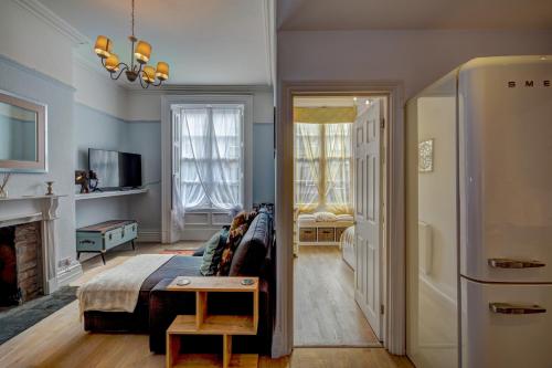 a living room with a bed and a fireplace at NEW Grade 2 historic flat in the heart of Chester in Chester