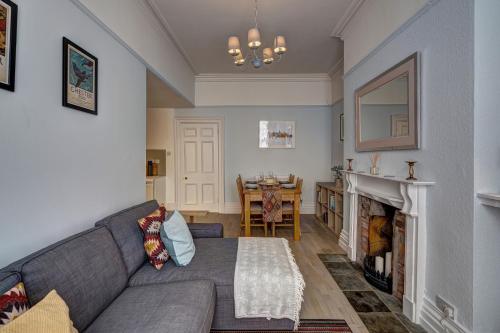 a living room with a couch and a table at NEW Grade 2 historic flat in the heart of Chester in Chester