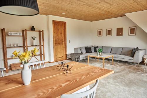 a living room with a table and a couch at Stylish vacation home - close to sea and nature in Hejls