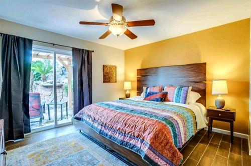 a bedroom with a bed and a ceiling fan at Tranquil oasis near Old Town, hot tub, mountain views in Scottsdale
