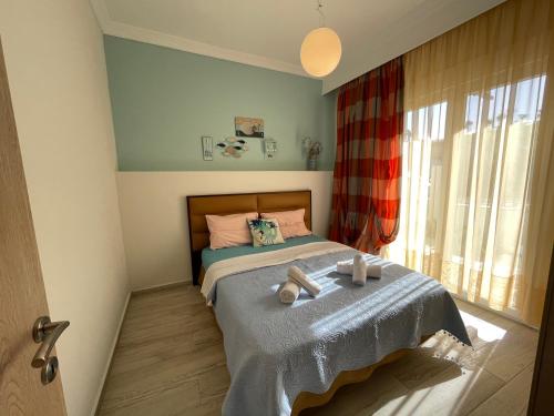 a bedroom with a bed with two towels on it at Central Number 10 in Néa Péramos