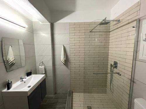 a bathroom with a shower and a sink at Central Number 10 in Néa Péramos