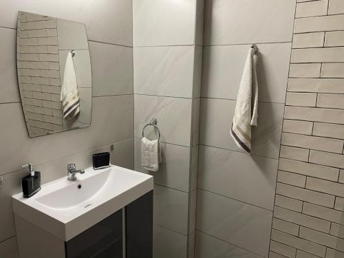 a bathroom with a sink and a mirror at Central Number 10 in Néa Péramos