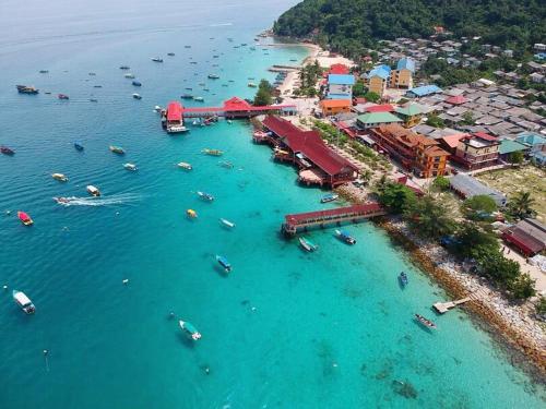 an aerial view of a beach with boats in the water at Ayah Perhentian in Perhentian Island