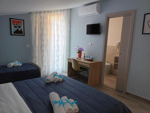 a hotel room with a bed and a desk and a bedroom at B&B Carpe Diem in Caserta