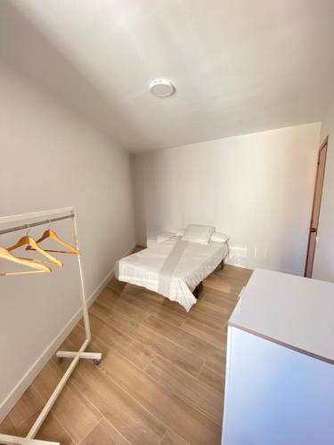 a bedroom with a bed and a wooden floor at Portonovo in Portonovo