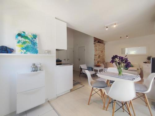 a kitchen and living room with a table and chairs at Apartment Garden, Korcula in Blato