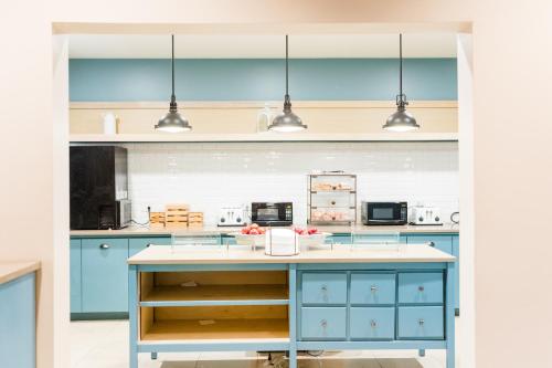 a kitchen with blue cabinets and a white counter top at Country Inn & Suites by Radisson, Helen, GA in Helen