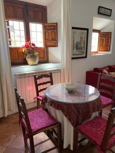 
a dining room table and chairs in a room at Hotel Santa Isabel La Real in Granada
