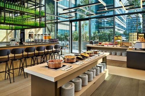 a restaurant with a table with food on it at YOTEL Singapore Orchard Road in Singapore
