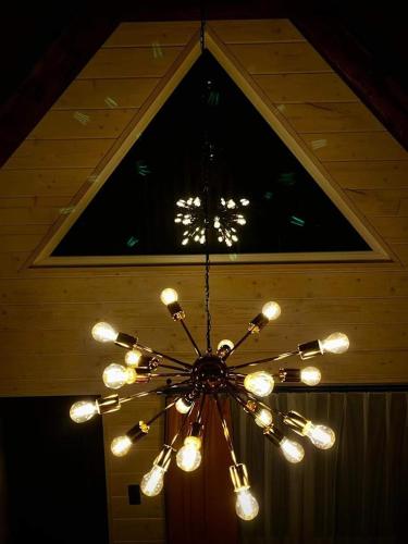 a chandelier hanging from a ceiling in a room at Księżycowy Domek Nad Potokiem in Wisła